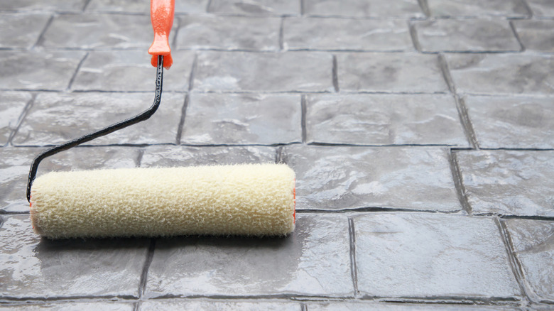 paint roller on a stamped concrete surface
