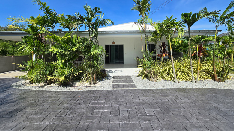 white house with stamped concrete driveway and patio
