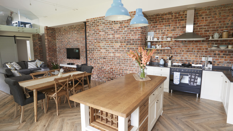 A modern kitchen with a brick feature wall