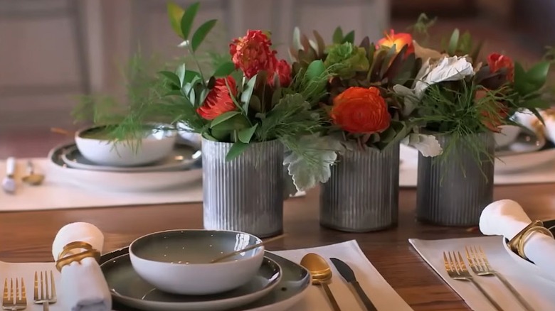 Closeup of galvanized metal vases with flowers inside