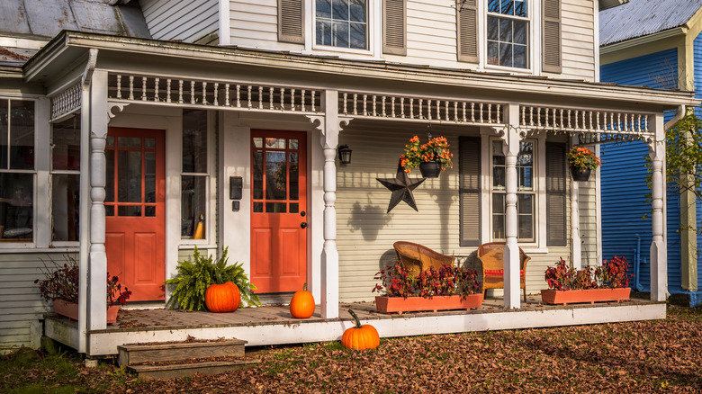 A porch with orange fall decorations