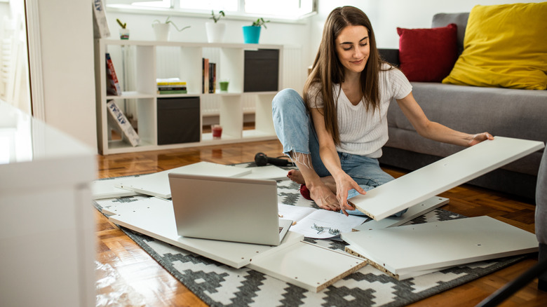 woman assembling furniture