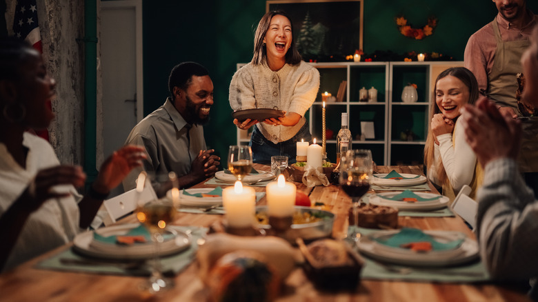 A family enjoying a holiday meal at a well-decorated table