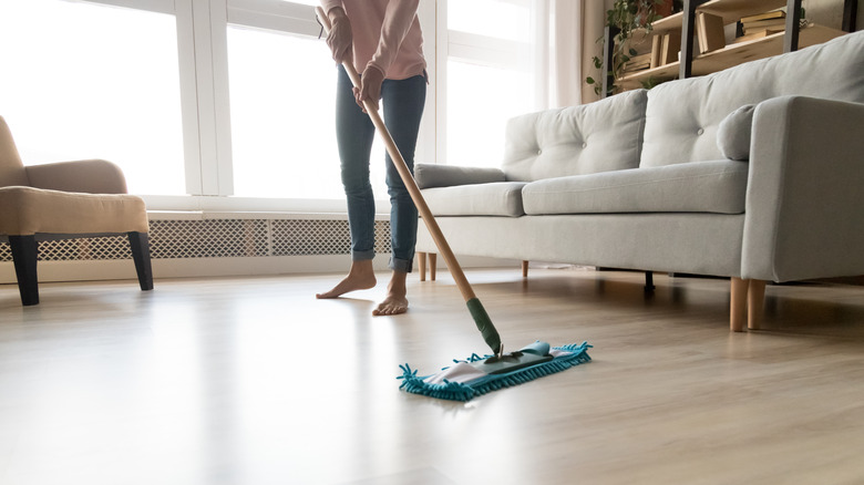 Woman mopping dirty floors