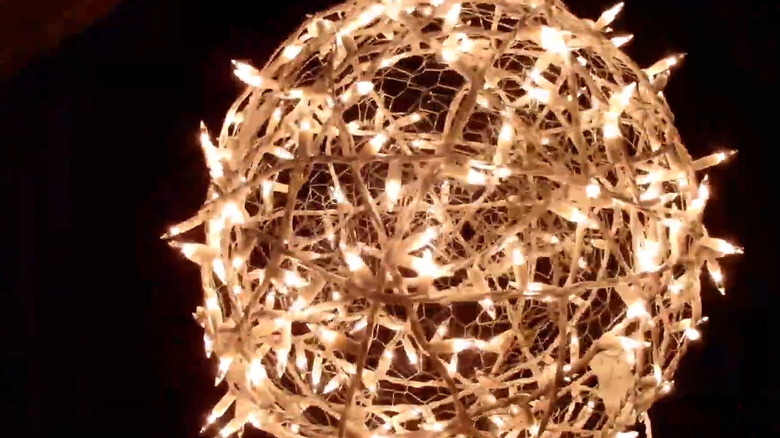 Glowing orb made from chicken wire wrapped in white string lights