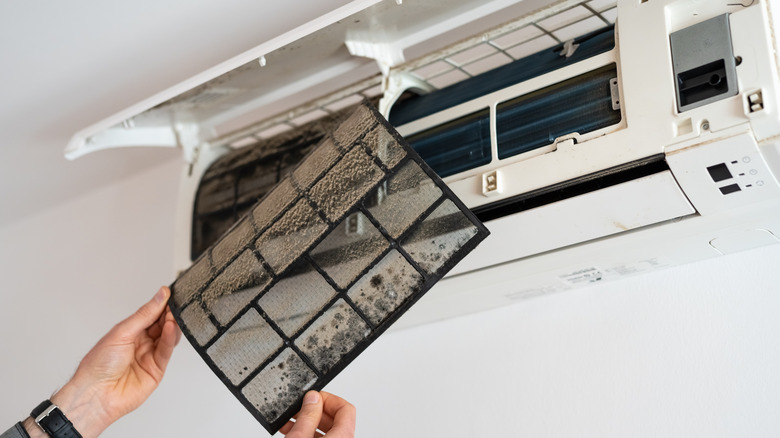 Removing dirty air filter from split system a/c unit