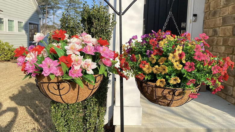 Two floral arrangements with silk flowers and hanging baskets