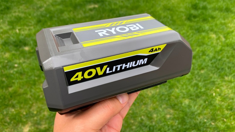 person holding Ryobi battery