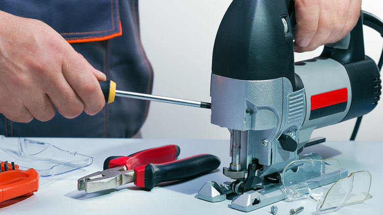 Taking apart a corded jigsaw to replace the carbon brushes