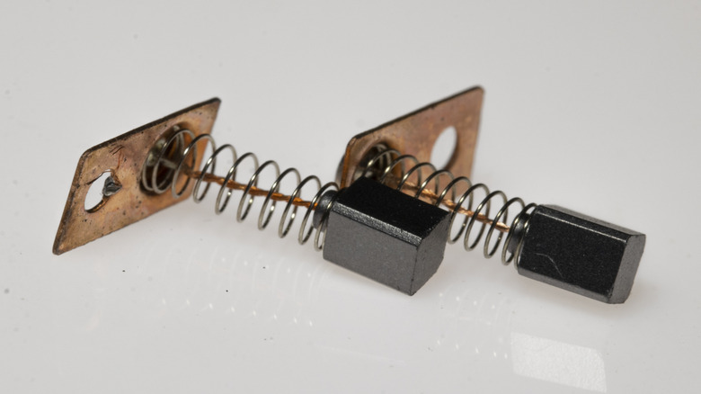 A pair of carbon brushes from a power tool motor