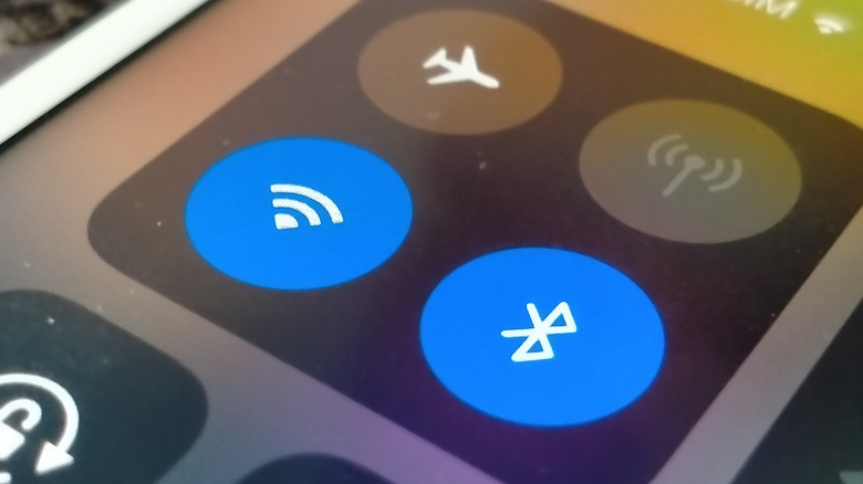 A phone screen shows icons indicating that WiFi and Bluetooth are on