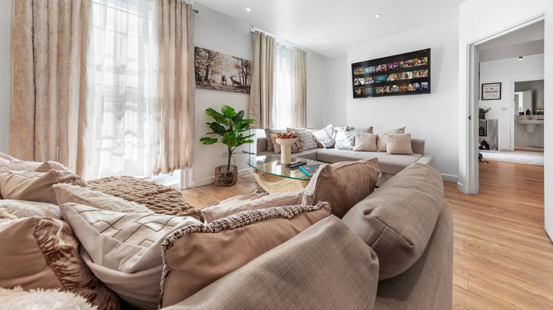 Entertainment room featuring two sofas and a large flatscreen TV mounted onto the wall