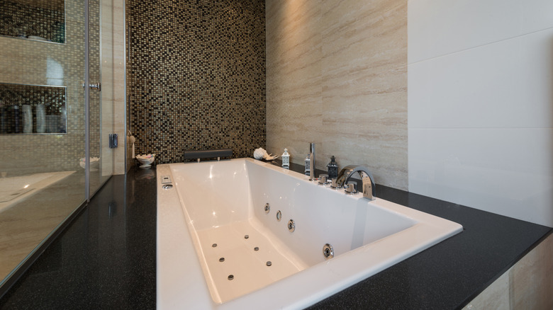 A bathtub with jets in a modern bathroom