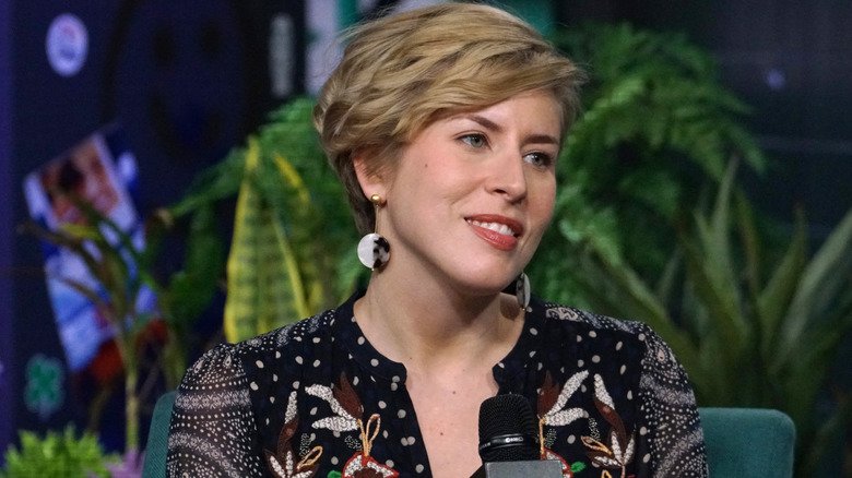 Erin Napier in front of plants and backdrop during an interview