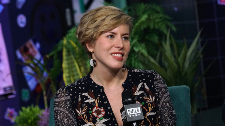 Erin Napier sits during an interview holding a microphone