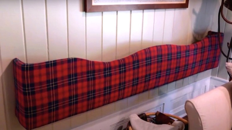 An upside down valance shelf with a plaid pattern