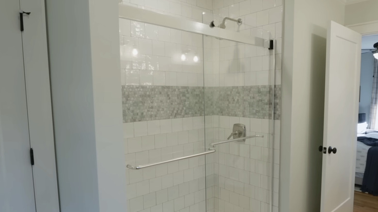 A modern bathroom with a white tiled shower