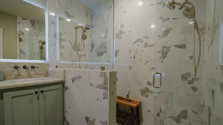 A modern bathroom with a marble tile shower