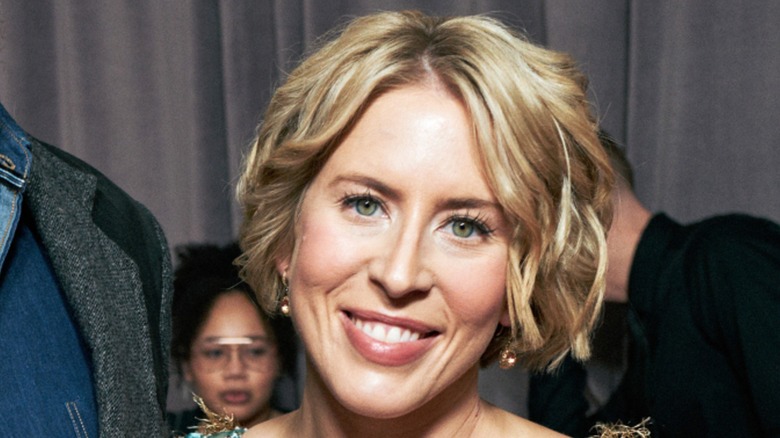 Erin Napier smiling while posing at an event