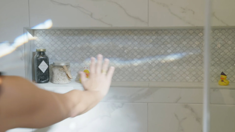 Fish scale tile on the back wall of a shower niche