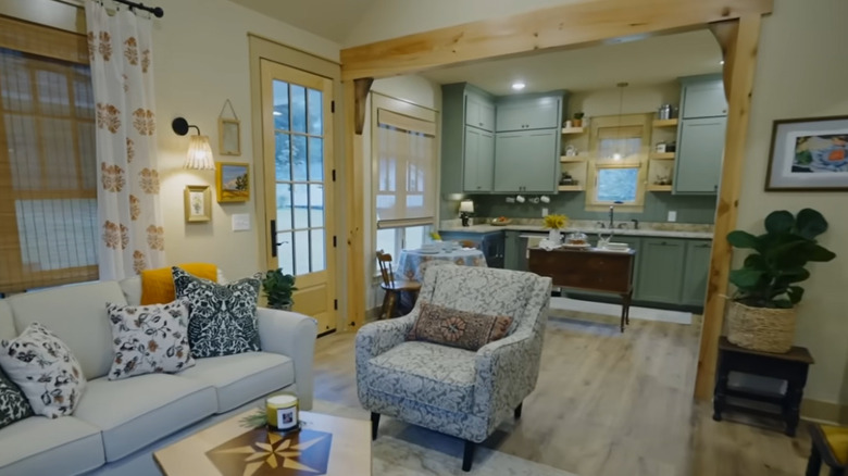 Erin Napier's "Home Town" project featuring unstained wood on the sides of a cased opening between the living room and the kitchen