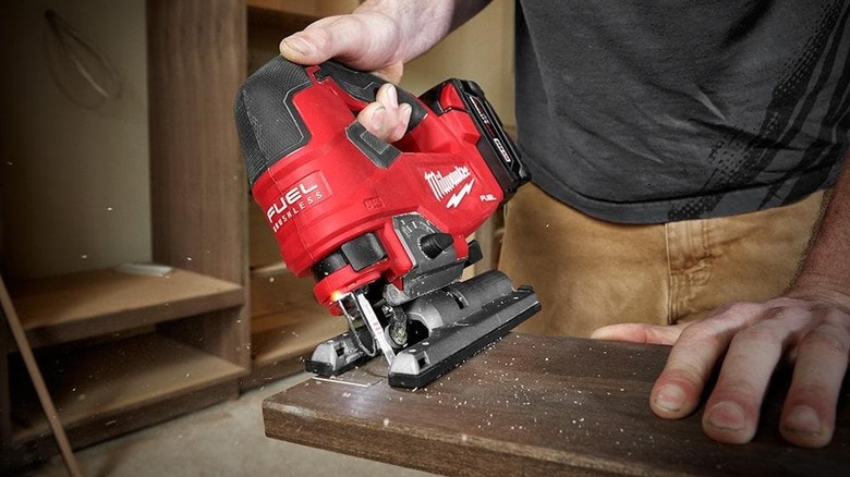 Person cutting wood with a jigsaw