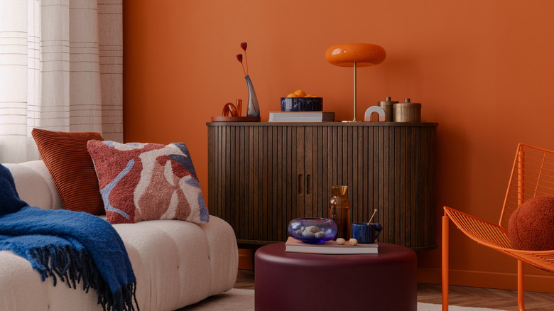 A room with an orange accent wall