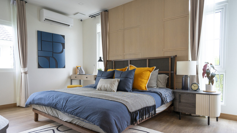 A bedroom with a wooden accent wall