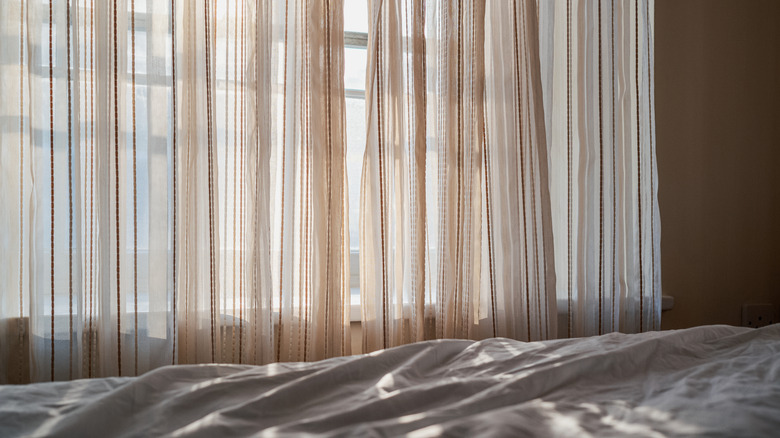 Light-colored washed linen curtains in a bedroom