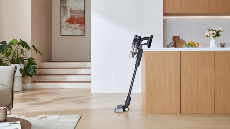 A Eureka vacuum leaning against a kitchen island