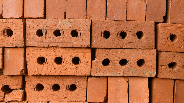 Layers of bricks with three holes laid next to one another