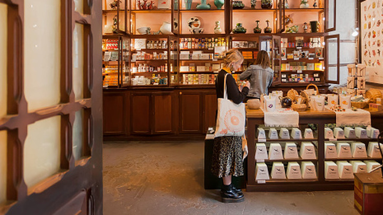 Woman looking at decor item while shopping in vintage store