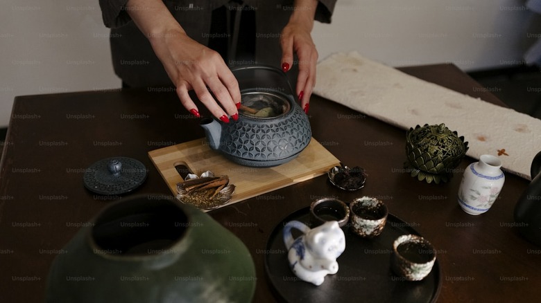 Hands using a tetsubin in Japanese tea ceremony