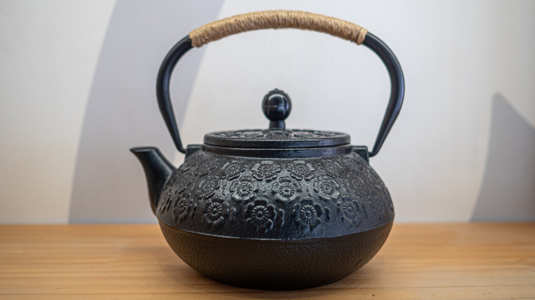 Black tetsubin with cherry blossom design and rope handle