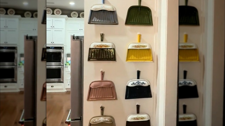 Screenshot of DIY decor with vintage dustpans hanging on the wall