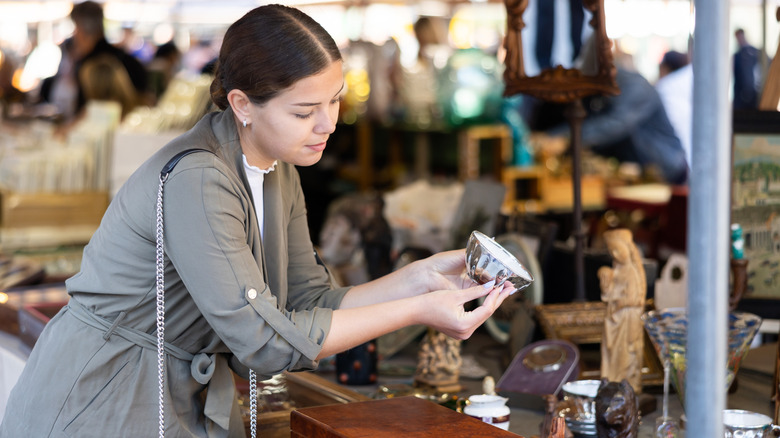 Woman shopping for antique housewares