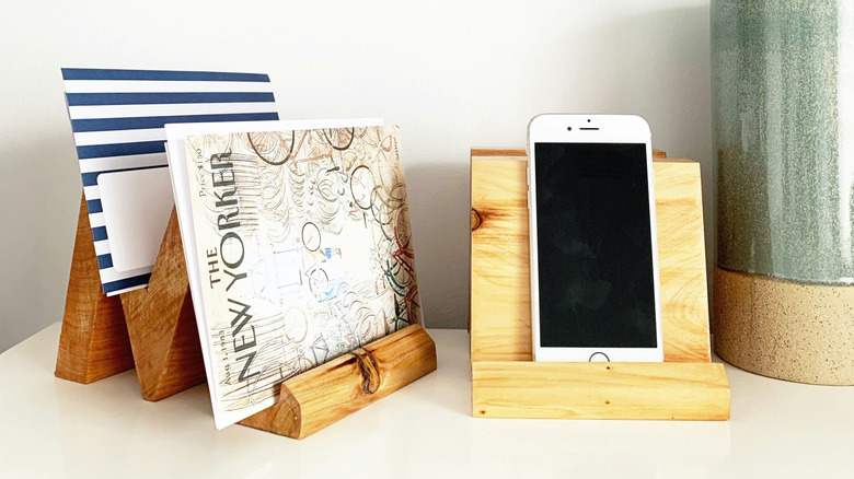 Magazines and letters on a tiered, wooden letter holders on a desk in an entryway