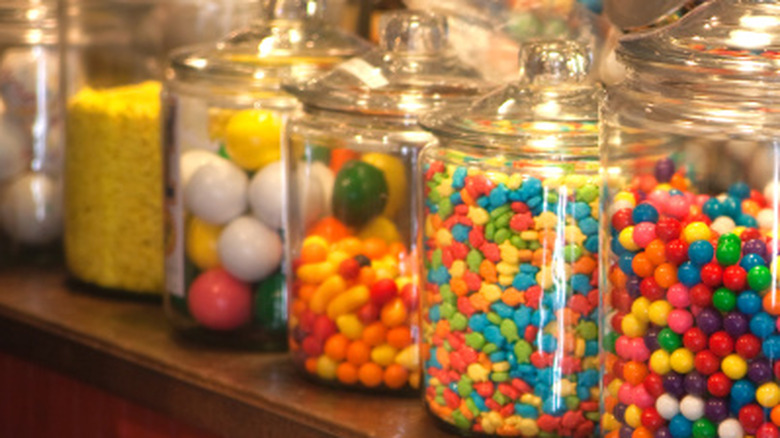 Closeup of glass jars with various candy inside