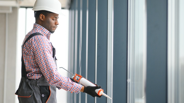 Man using caulk gun