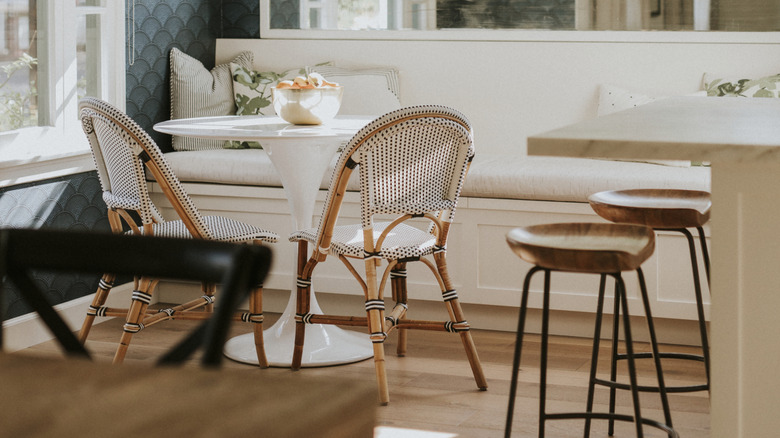 Retro seating area with tulip table, French cafe chairs, and banquette