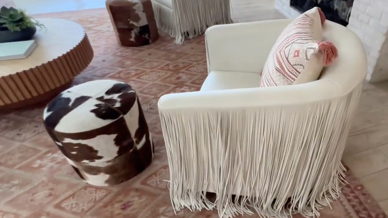 Cream leather fringe accent chair in living room.