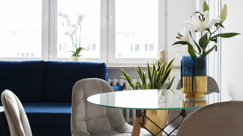 A round glass table in a home reflects light.