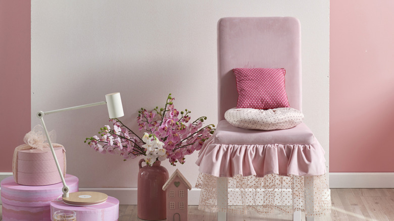 Pink chair with ruffles and other pink decor items