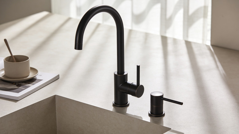 A modern sink with an oil-rubbed bronze faucet