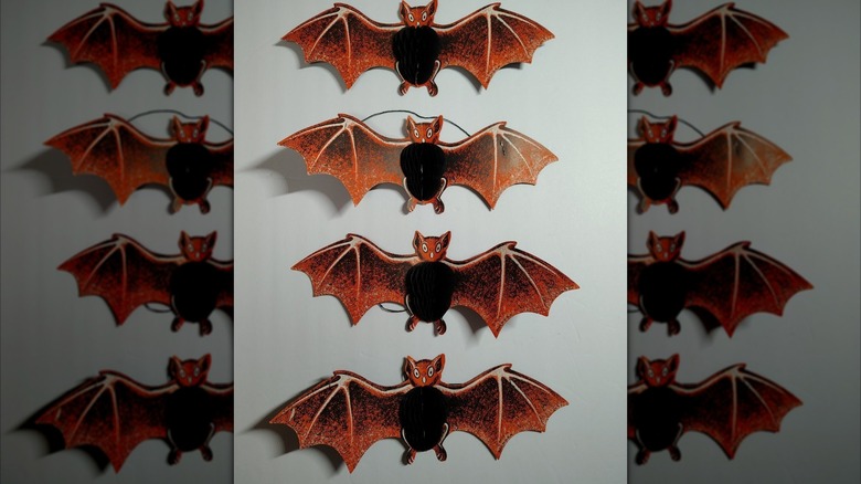 A set of vintage paper bats with black honeycomb tissue bellies