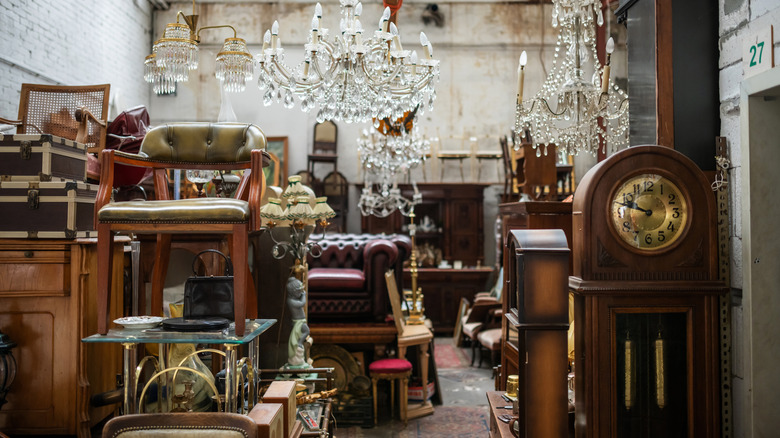 furniture in a thrift store with antique leather club chair in the back