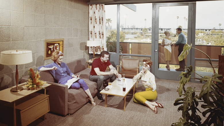 Young people in the '60s gathering in a living room.