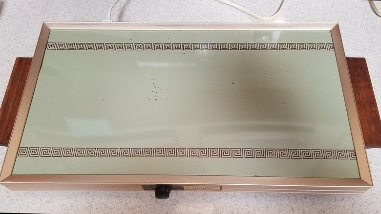 A vintage warming tray from the 1970s on a countertop