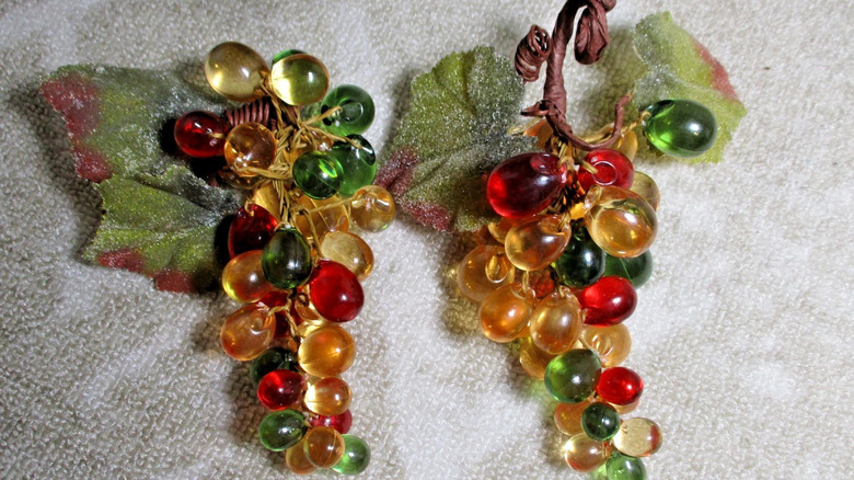 Two bunches of multicolored Lucite grapes side-by-side