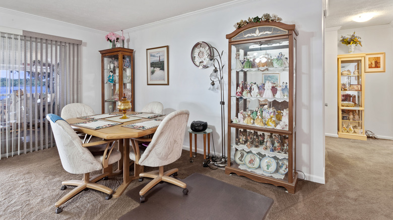 A retro room with table set and curio cabinets